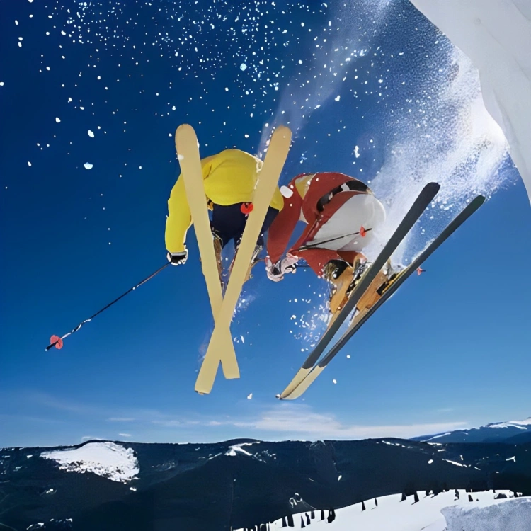 Skiers soaring through snowy sky.